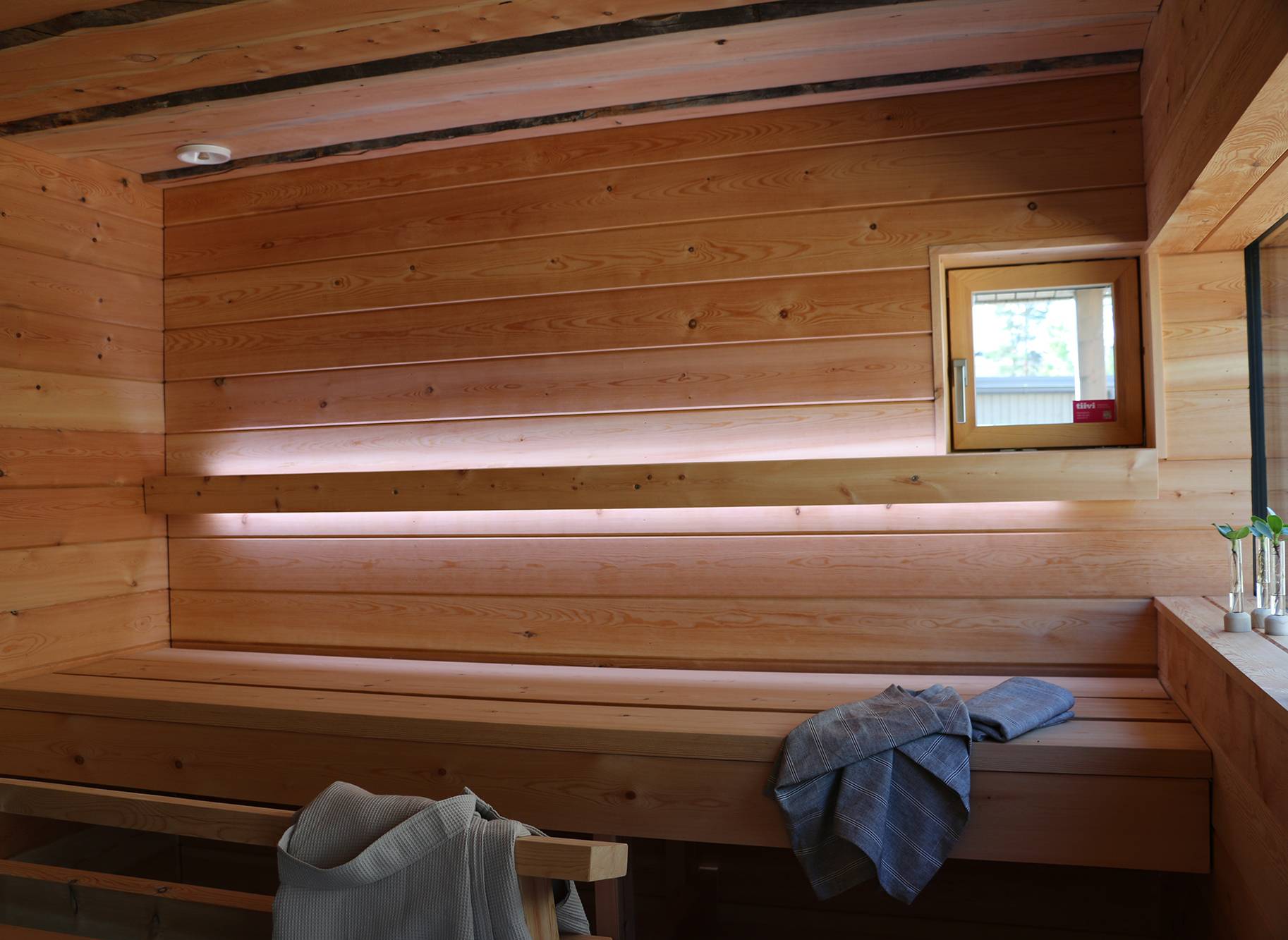 Osvětlení sauny realizované pomocí led světelných pásů na opěradle. Led pásky svítí směrem nahoru a dolů. Ledstore.fi