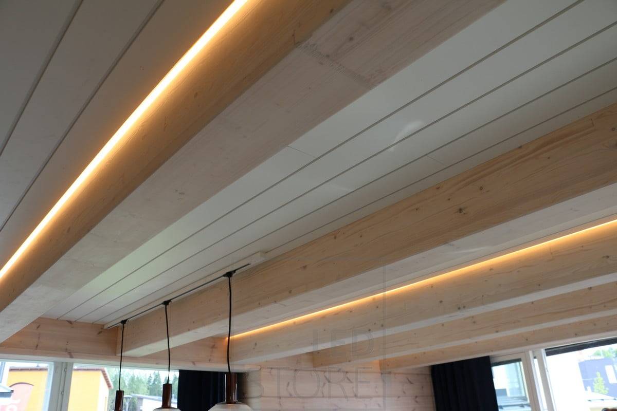 LED pásky v rohu stropu a stropní lišty, které vytvářejí atmosférické osvětlení v obývacím pokoji. Ledstore.fi